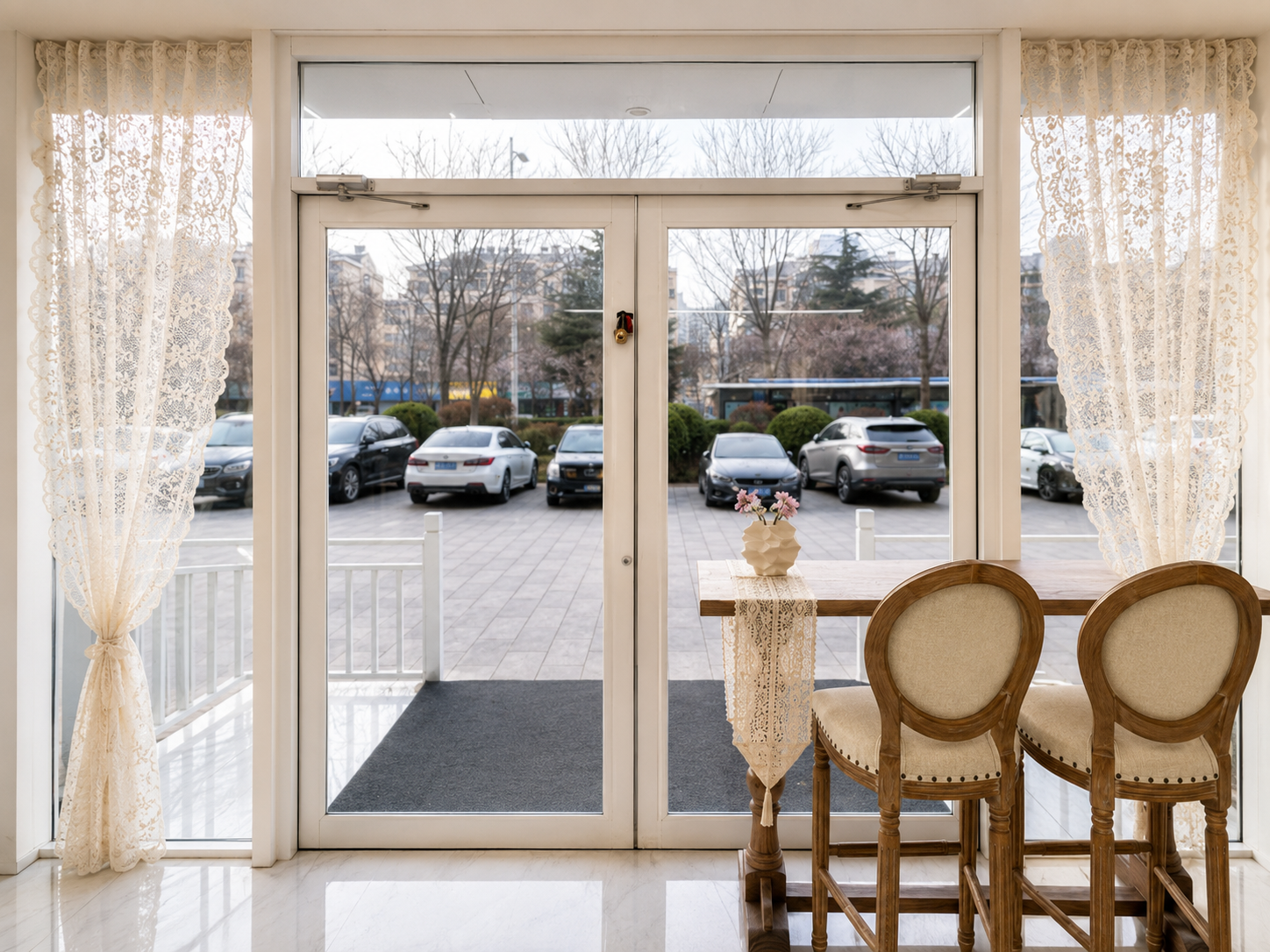 Embroidered sheer curtain used at a commercial entrance